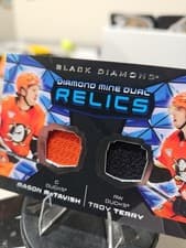 2025-26 Upper Deck Black Diamond Diamond Mine Dual Relics Mason McTavish/Troy Terry #DMDR-MT card
